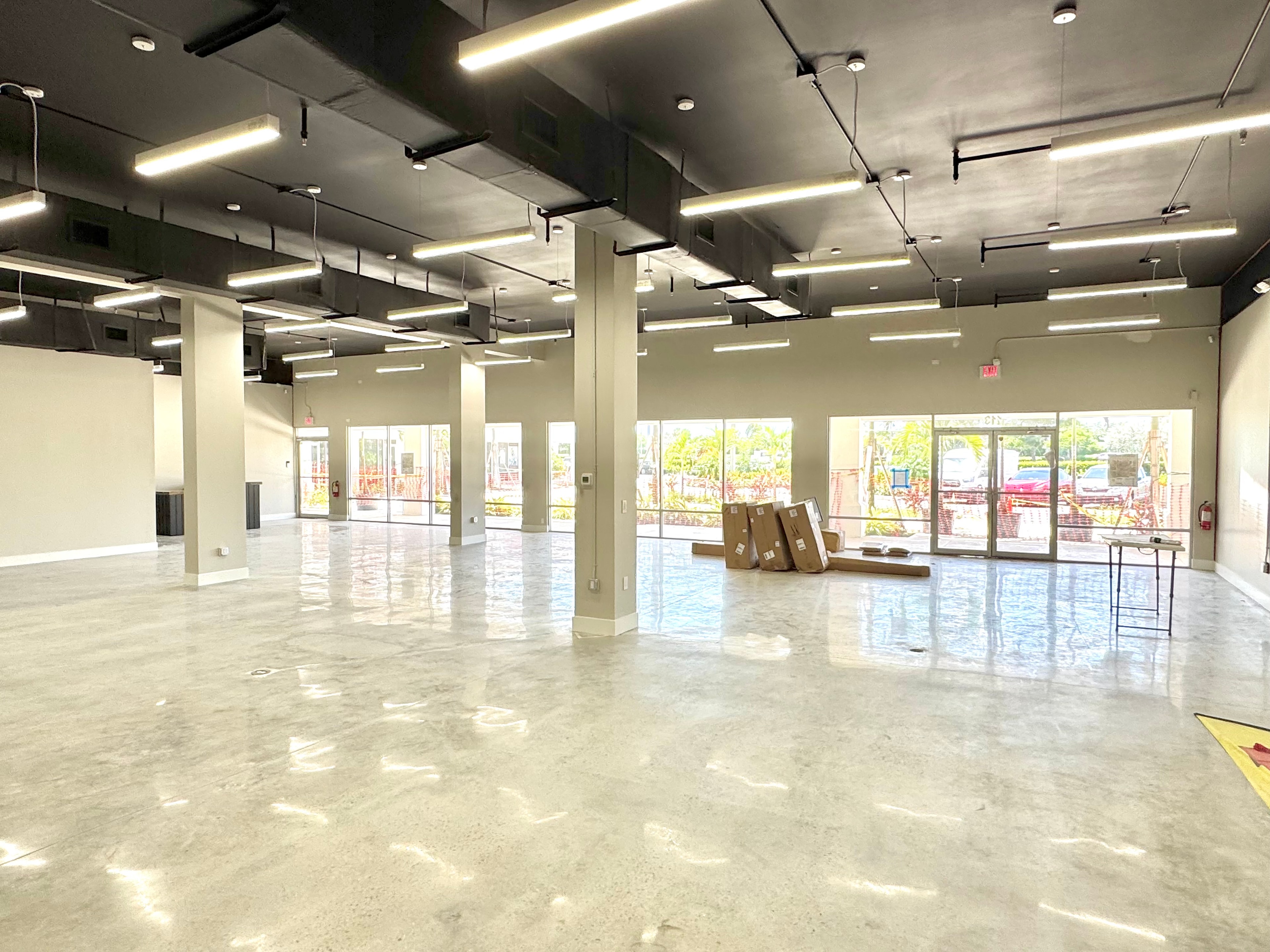 8793 Tamiami interior with black ceiling and storefront windows